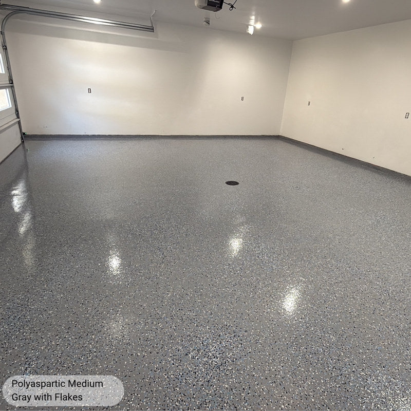 Finished medium broadcast flake garage floor in Medium Gray polyaspartic, high gloss and reflective under garage lighting