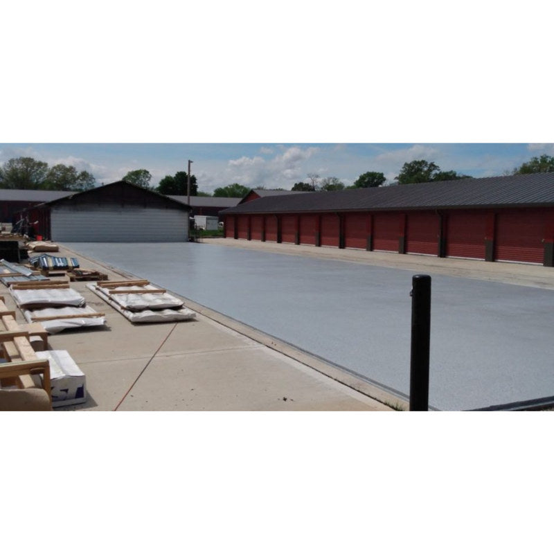 Tinted gray coated concrete drive aisle at an outdoor self-storage facility