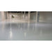 Glossy gray tinted floor coating across a large open commercial interior