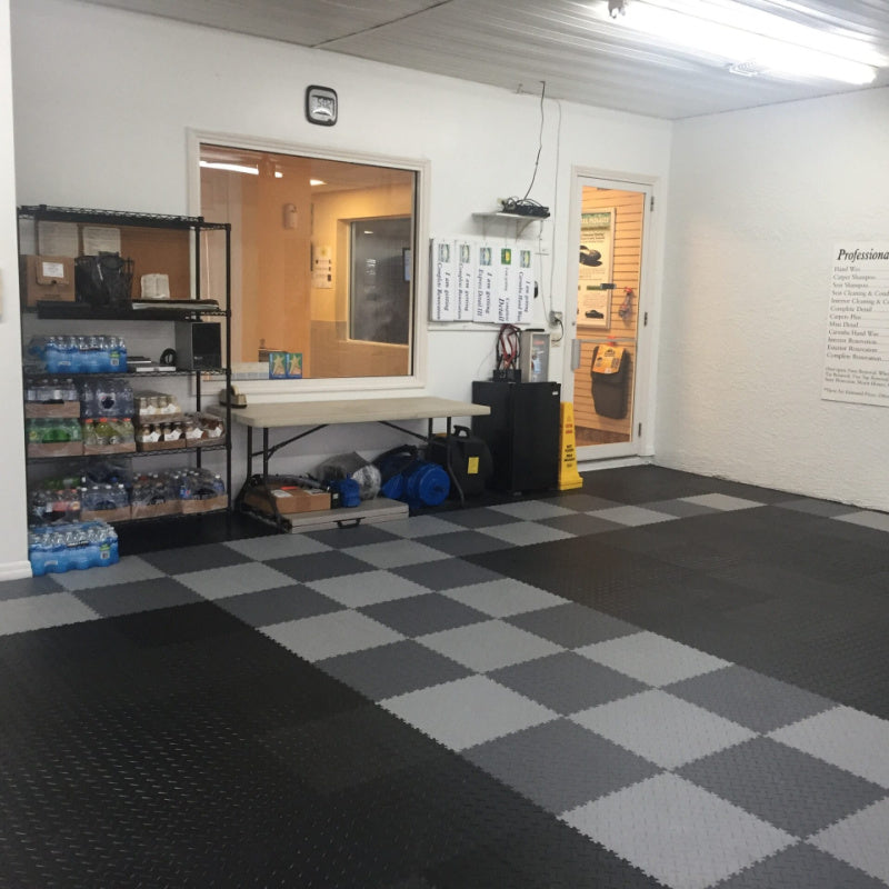 Diamond Plate PVC Tiles Installed In A Car Wash With Black Parking Spot And Dark And Light Gray Checkered Lanes