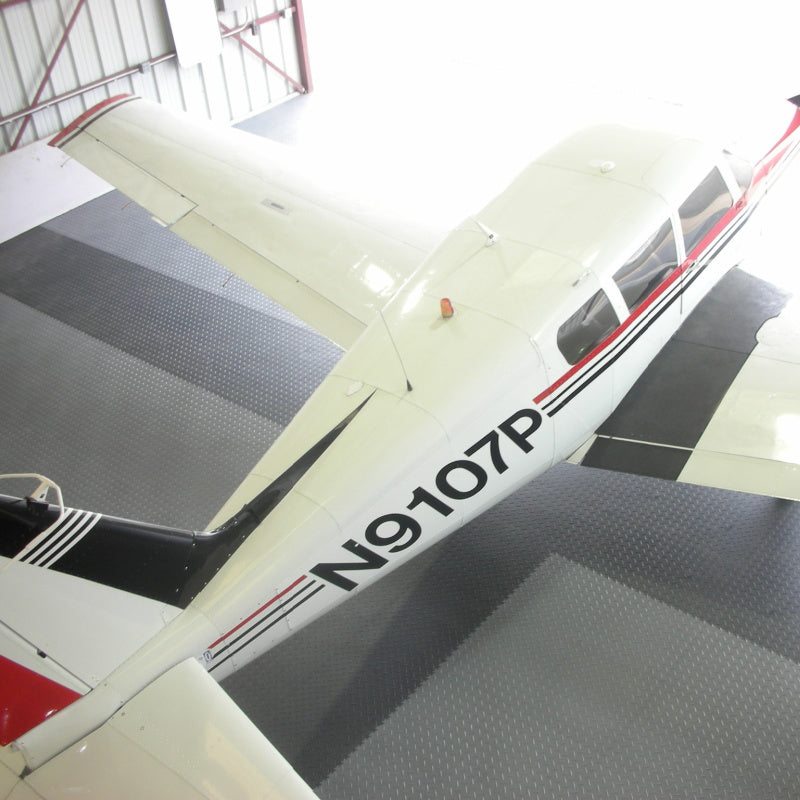 SupraTile Diamond Plate PVC Flooring Showing Its Durability With An Airplane Parked On It In A Hangar