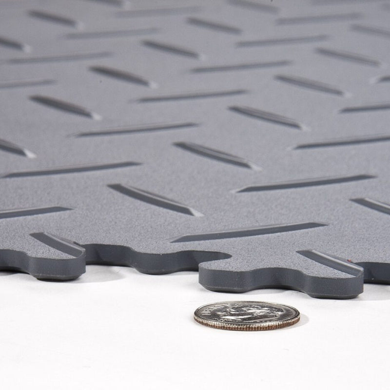 A Close Up Of SupraTile Diamond Plate PVC Garage Tiles Shown Next To A Dime To Show Thickness Comparrison