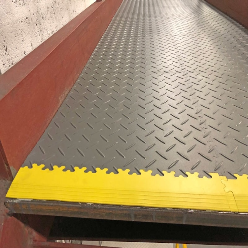 A SupraTile Diamond Plate PVC Floor Finished With Nice Yellow Edging Using The Dovetail Interlocking Pattern