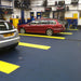 Textured PVC Garage Tiles With T-Joint Installed In An Autoshop