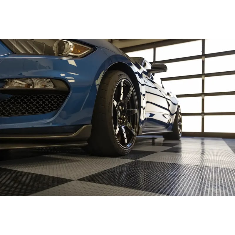 Stylish garage scene showcasing a blue Shelby Mustang on Racedeck Garage Flow Flooring Tiles, emphasizing the car's sleek profile and design