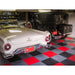 Classic White Car and Vintage Black Vehicle on Red and Gray Checkered RaceDeck XL Garage Floor with Automotive Tools and Parts in a Well-Organized Garage