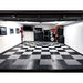 Spacious garage with Race Deck Tiles, featuring a classic black and gray checkered pattern and organized tools