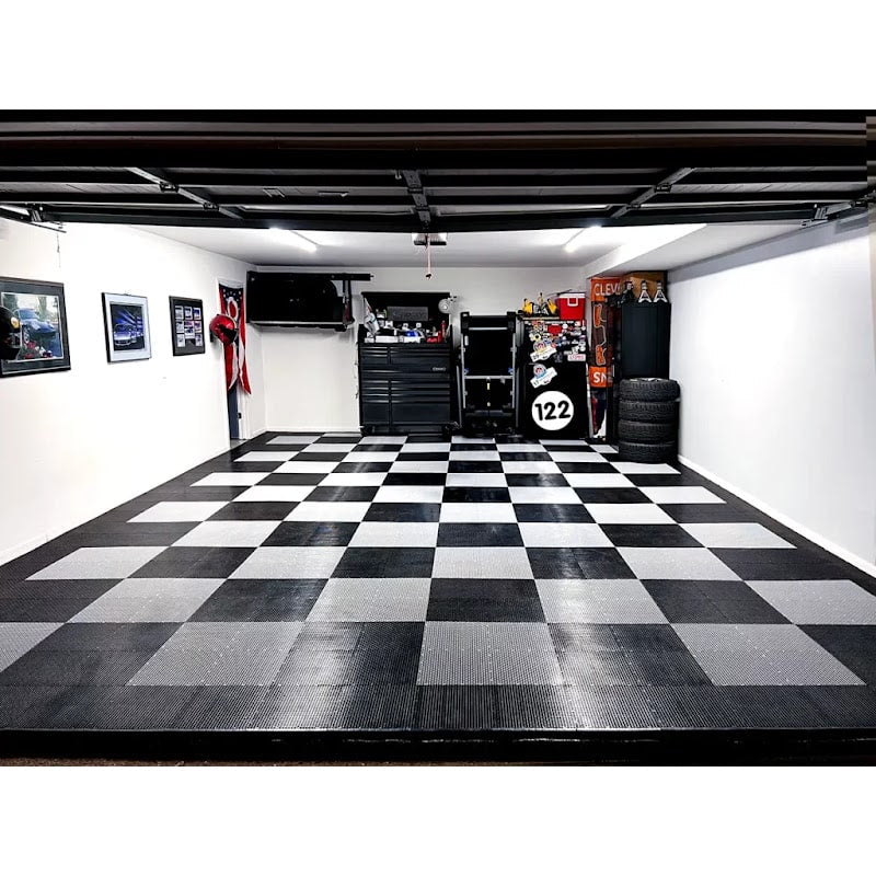 Spacious garage with Race Deck Tiles, featuring a classic black and gray checkered pattern and organized tools