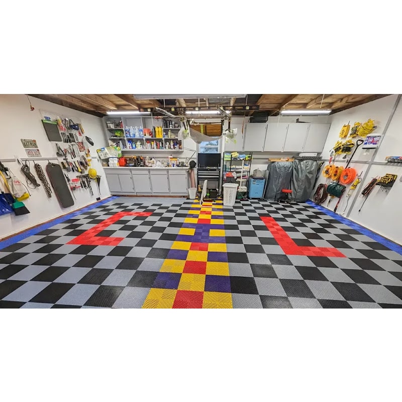 Functional garage space with Racedeck Garage Flow Flooring Tiles, highlighting a vibrant checkered floor with colorful accents for organization