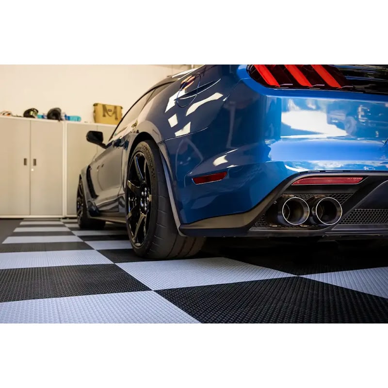 Stylish garage scene featuring Racedeck Flooring, showcasing a blue Mustang on a classic black and white checkered floor