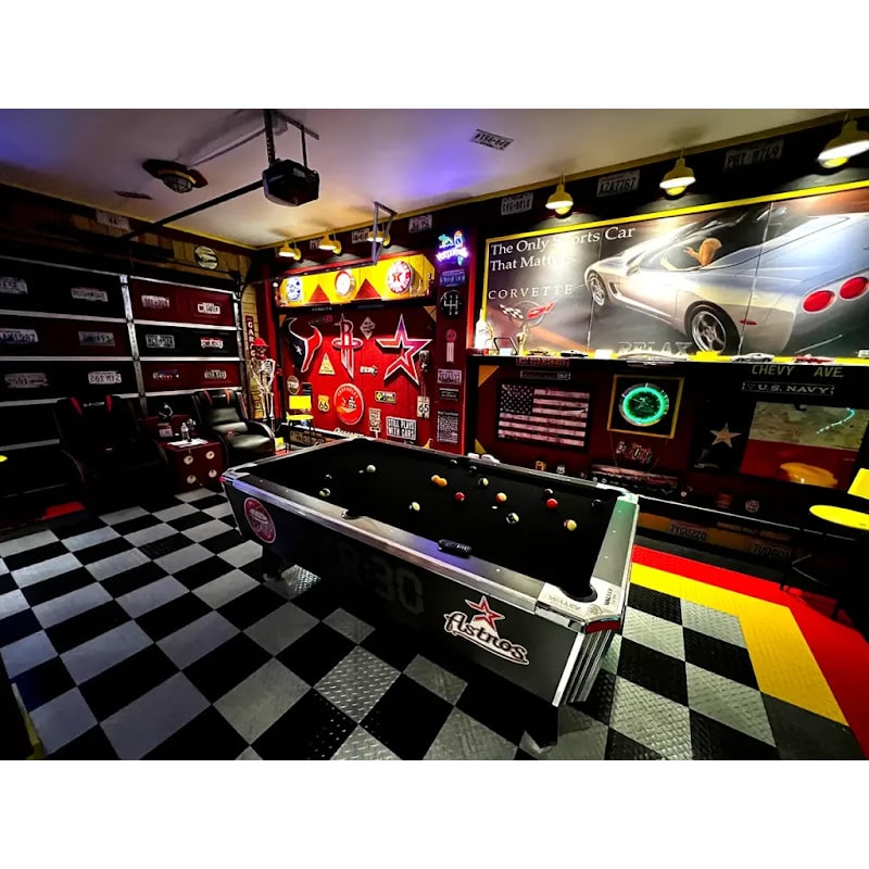 Entertainment space featuring RaceDeck TuffShield Diamond Flooring Tiles, showcasing a pool table and vintage decor with a checkered floor
