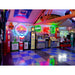 Themed entertainment space featuring TuffShield Racedeck Garage Flooring, adorned with vintage gas station memorabilia and colorful neon sign