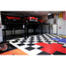 Spacious Garage with Black and White Checkered RaceDeck Tile XL, Three Classic Cars on Lifts, and a Vintage Motorcycle Parked Below